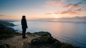 A person standing alone at sunrise